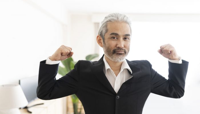 asian senior business man shows off his muscles self-confidence, boss
