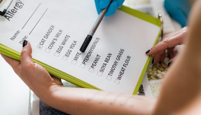 Immunology Doctor Looking at a List With Allergens